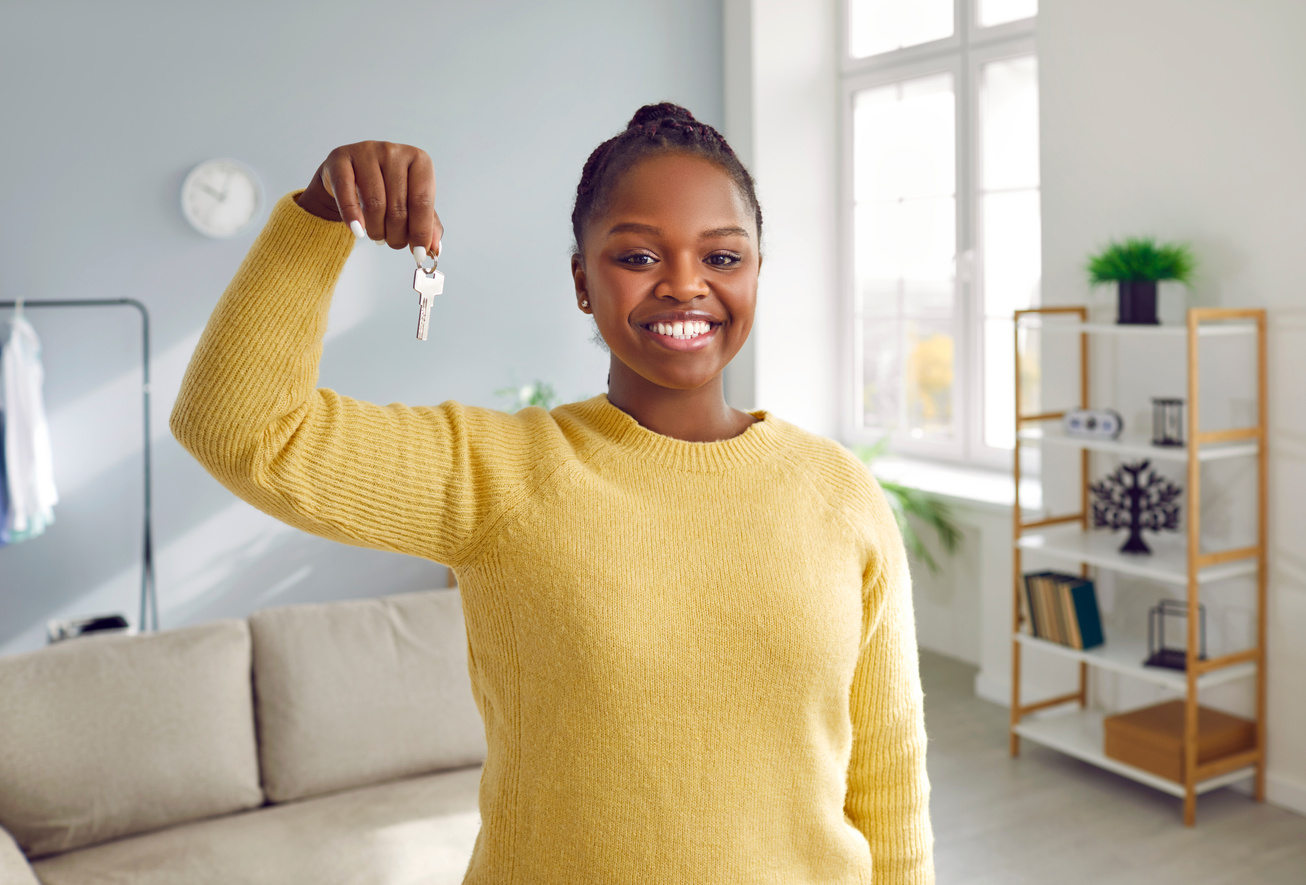 Excited Young Woman Tenant Renter Showing Key to New Apartment